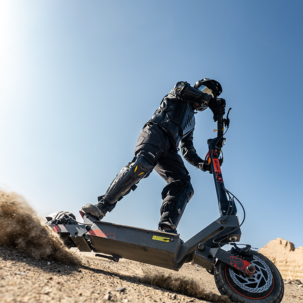 Helmeted rider using a KuKirin G2 Ultra electric scooter off road