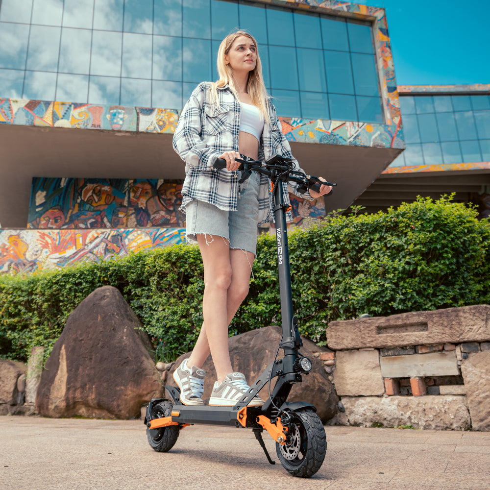 Rider standing beside a KuKirin G2 Pro electric scooter