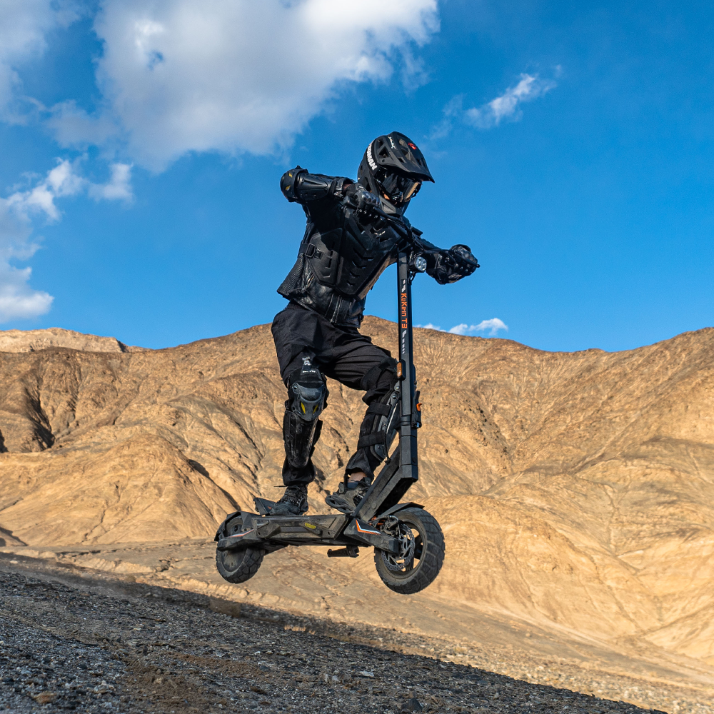 Helmeted rider jumping with a KuKirin T3 electric scooter