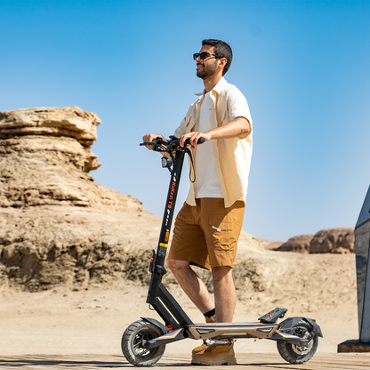 Rider using a KuKirin T3 electric scooter on dry terrain